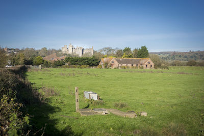 Sussex countryside with a derelict farmhouse and arundel castle in the background