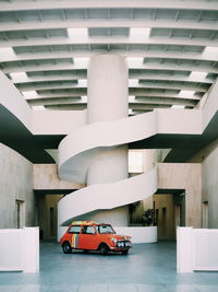 Cars parked in parking lot by building