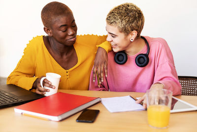 Lesbian couple talking while working at home