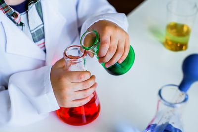 Midsection of man pouring wine in glass