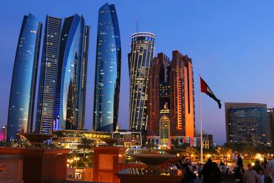 Panoramic view of illuminated buildings against sky at dusk