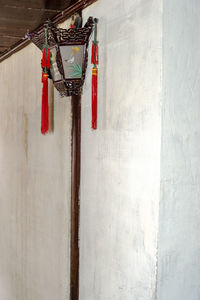 Low angle view of electric lamp hanging on wall