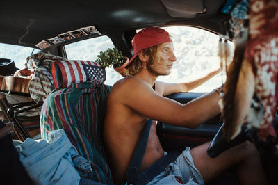 Young woman sitting in car