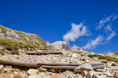 Scenic view of rocky mountains against blue sky