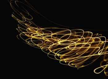 Light trails against black background