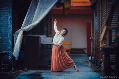 Side view of woman standing at market stall