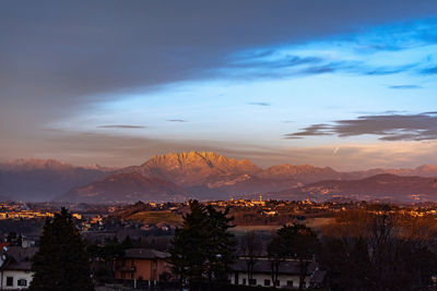 Aerial view of townscape against sky at sunset