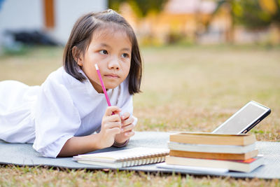 Portrait of a smiling young woman reading book