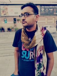 Portrait of young man wearing sunglasses standing outdoors