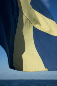 Close-up of flag against blue sky