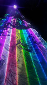 Low angle view of illuminated lighting equipment at night