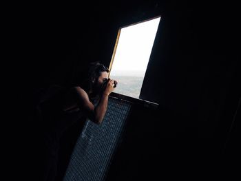 Young woman using mobile phone at home