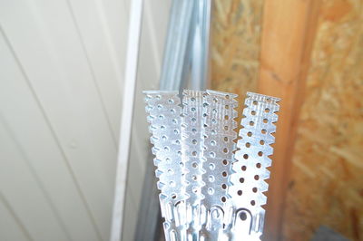 Close-up of curtain against window at home