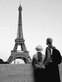 Rear view of woman with daughter looking at eiffel tower