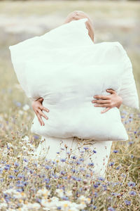 Midsection of woman with umbrella on land