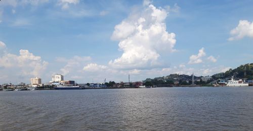 Panoramic view of sea and buildings against sky