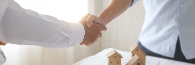 Midsection of couple holding hands