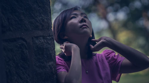 Portrait of young woman looking away outdoors