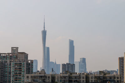 Modern buildings in city against clear sky