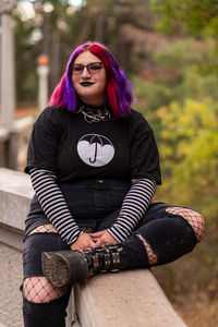 Portrait of young woman sitting on steps
