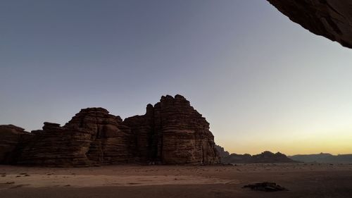 Ruins of rock formation against clear sky