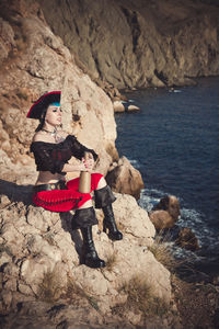 Portrait of a pirate woman at the beach. in anticipation of a pirate ship