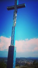 Low angle view of crane against blue sky