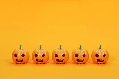 Close-up of jack o lantern against yellow background