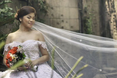 Portrait of happy bride outdoors