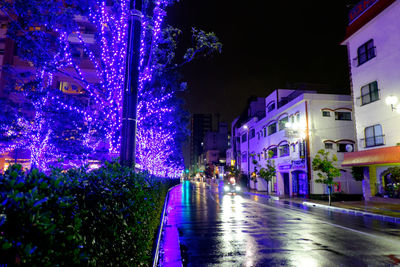 Illuminated city street at night