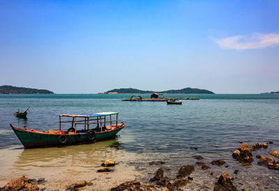 View of boats in sea against sky