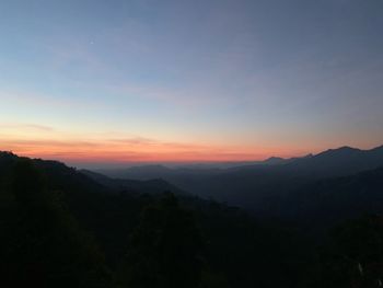 Scenic view of silhouette mountains against sky at sunset