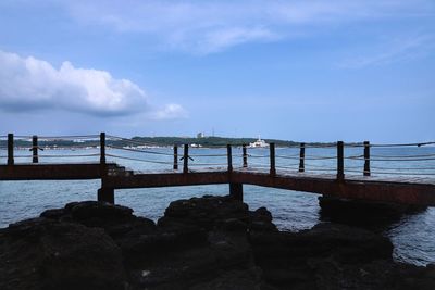 Pier over sea against sky