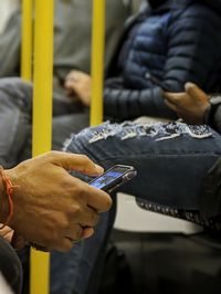 Midsection of man using mobile phone