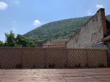 View of building and mountains against sky