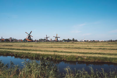 Traditional windmill on field against sky