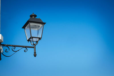 Gas light against blue sky