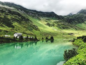 Scenic view of lake and mountains against sky