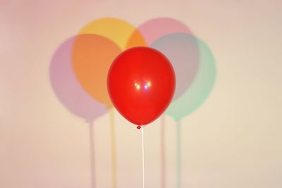 Close-up of multi colored balloons against white background