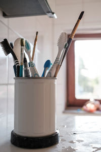 Close-up of paintbrushes on table