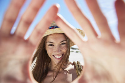 Portrait of smiling young woman on the beach