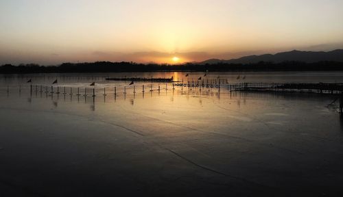 Scenic view of lake against sky during sunset