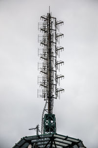 Low angle view of communications tower against sky