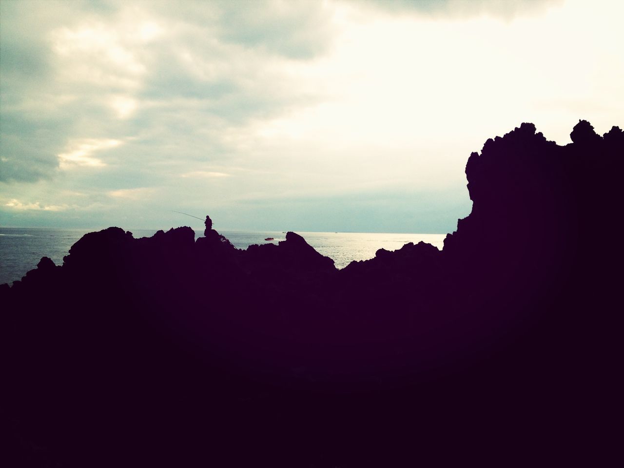 silhouette, sky, scenics, tranquility, tranquil scene, rock formation, beauty in nature, sea, nature, rock - object, cloud - sky, sunset, horizon over water, cliff, idyllic, water, dusk, cloud, travel destinations, tourism