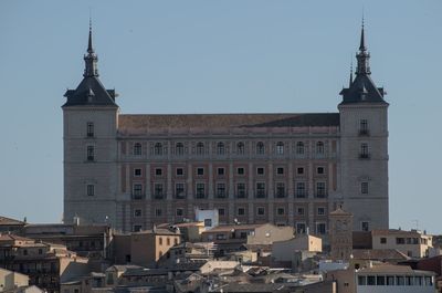 Buildings in city against clear sky