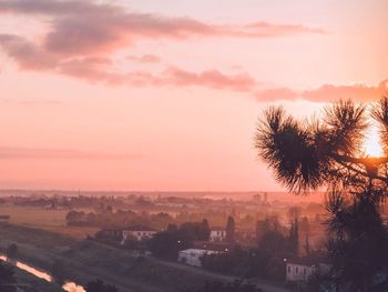 Aerial view of townscape against sky at sunset