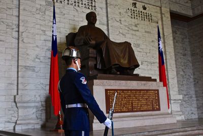 Security guard standing by statue in historic building