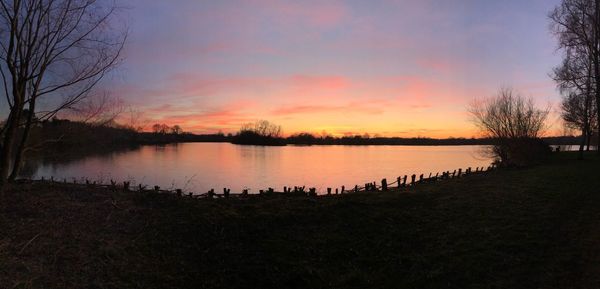 Scenic view of lake against sky during sunset