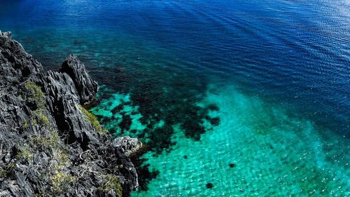 High angle view of rocks by sea