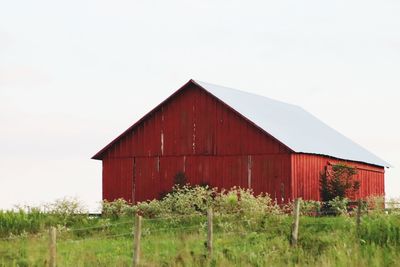 Barn on field against sky